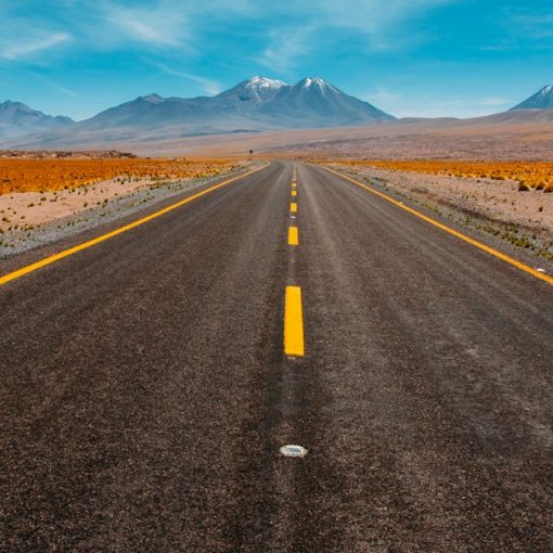 Lone road going to mountains, illustrating a roadmap to the public cloud