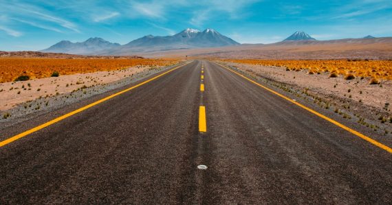 Lone road going to mountains, illustrating a roadmap to the public cloud