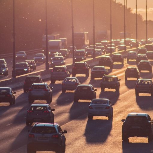 Heavy traffic on a multi-lane highway at golden hour, illustrating the drive to public clouds