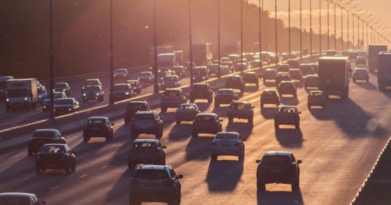 Heavy traffic on a multi-lane highway at golden hour, illustrating the drive to public clouds