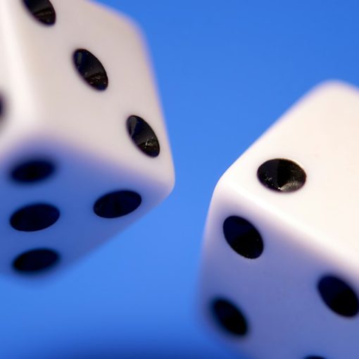 2 white dices on blue surface, illustrating risk management in cloud computing