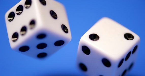 2 white dices on blue surface, illustrating risk management in cloud computing
