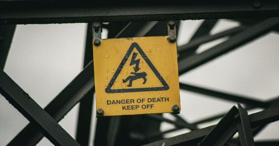 A sign warning of danger of death on a bridge, illustrating mitigating the risks of cloud computing