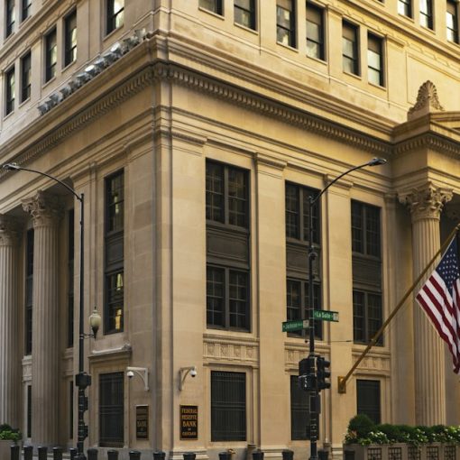 Classic bank building with columns and a flag, illustrating the risks of shadow IT in banks