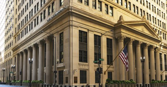Classic bank building with columns and a flag, illustrating the risks of shadow IT in banks
