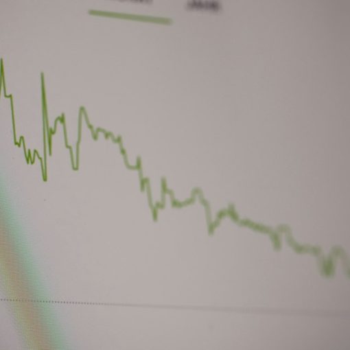 A green line graph showing stock market trends on a digital screen, illustrating Gartner's SaaS market forecast