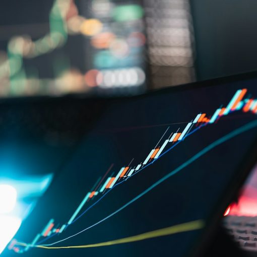 A tablet displaying a rising market graph on a desk, illustrating SaaS revenue growth