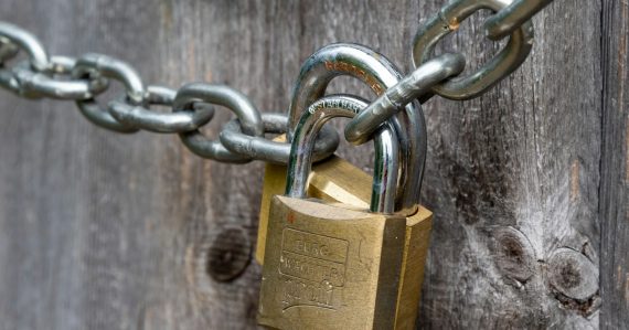 Brown padlock on brown wooden fence, illustrating secure cloud computing research tools