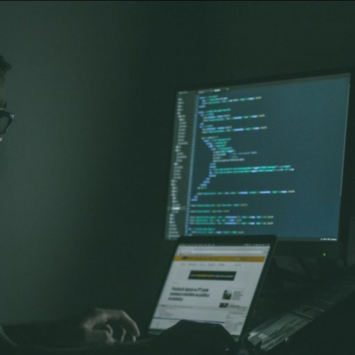 Person using laptop computers, illustrating CIA investment in secure virtualization