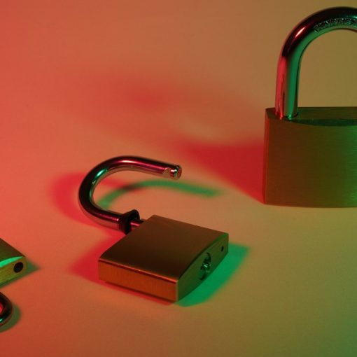 Green and silver padlock on yellow surface, illustrating securing VoIP for small businesses