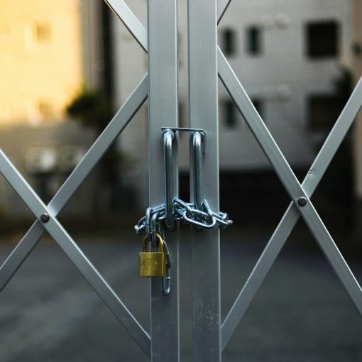 Gray steel gate closed with padlock, illustrating securing the cloud