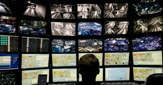 A man sitting in front of multiple monitors, illustrating preparing for the next IT security trend