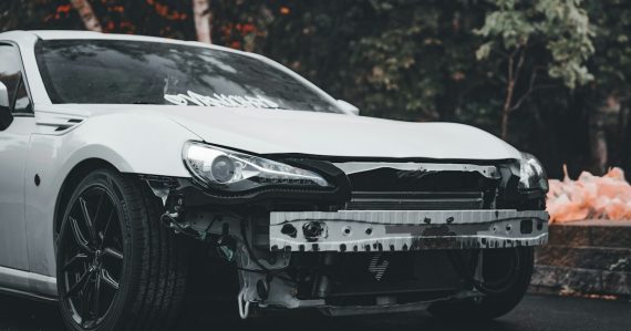 White car with bumper removed outdoors, illustrating stalled server virtualization