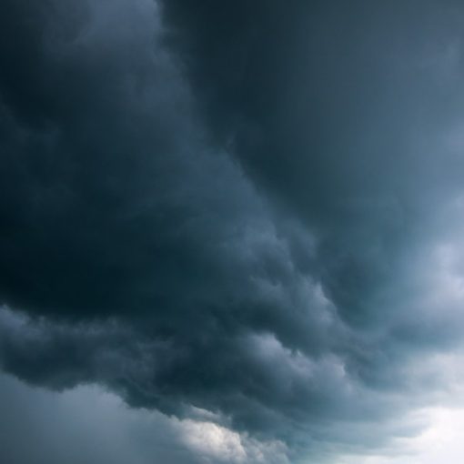 A large storm moving across the sky over a body of water, illustrating shared services opportunities in government