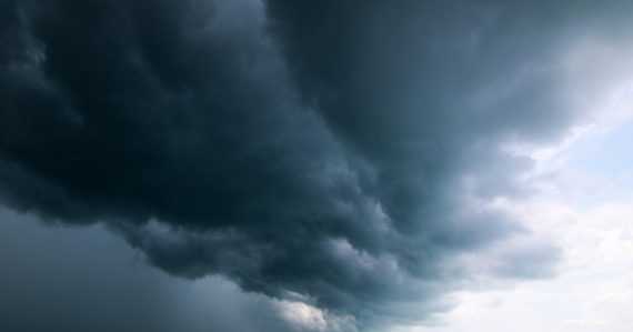 A large storm moving across the sky over a body of water, illustrating shared services opportunities in government