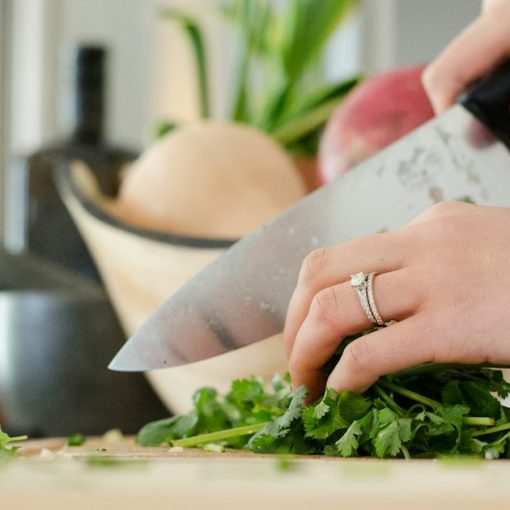 Person cutting vegetables with knife, illustrating reducing OPEX with desktop virtualization