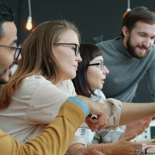 Diverse team collaborating around a computer screen, illustrating the cloud as the way forward for SMBs