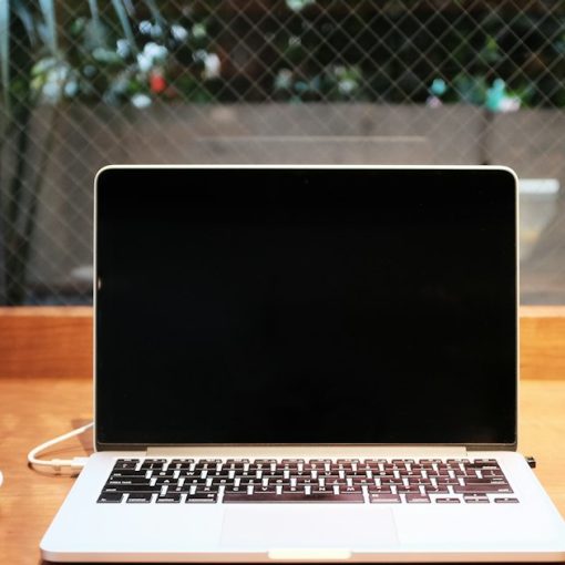 Laptop computer beside coffee mug, illustrating cloud computing for small startups