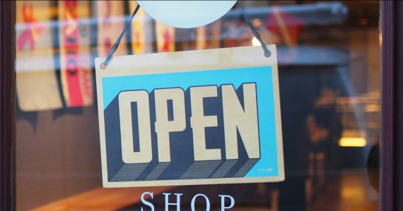 Gray and blue Open signage, illustrating cloud opportunities for SMBs and providers