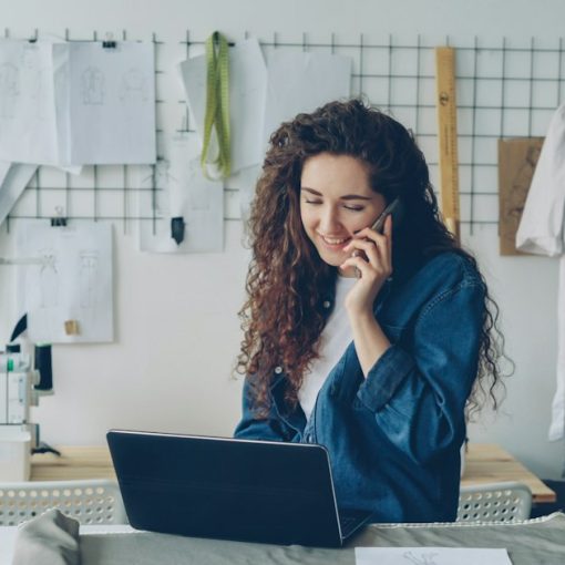 Small business owner on the phone working at a laptop, illustrating cloud adoption and revenue growth