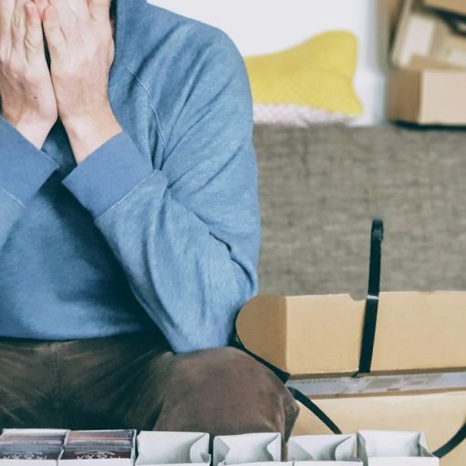 Man covering face with both hands while sitting on bench, illustrating SMBs struggling with virtualization