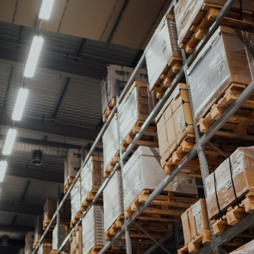 Brown cardboard boxes on white metal rack, illustrating the new IT supply chain