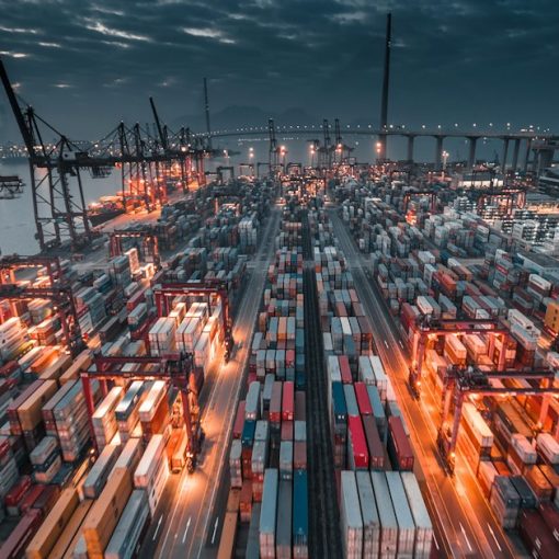 A busy shipping port with stacked containers and cranes, illustrating reshaping supply chain management with the cloud