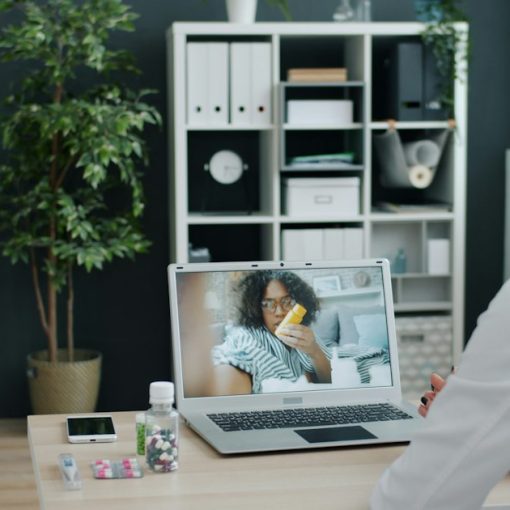 Doctor consulting patient via video call on laptop, illustrating telemedicine and cloud computing in healthcare