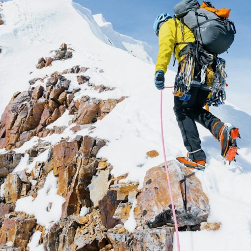 Climber ascending a snow-covered mountain, illustrating the top challenges to cloud computing