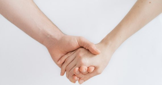Woman and man holding hands, illustrating trust in cloud computing