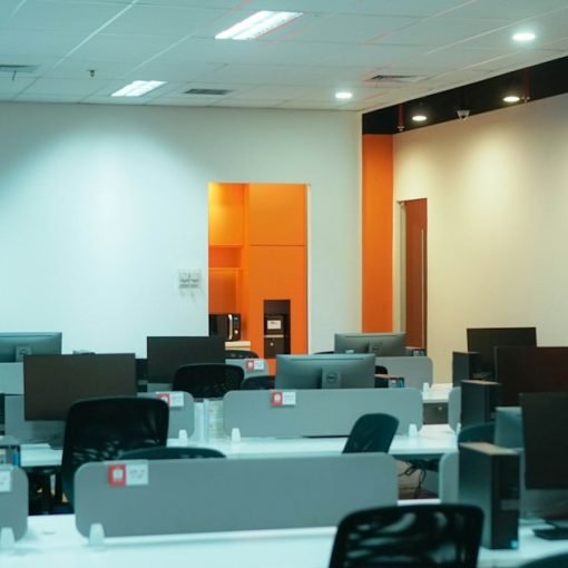 A room filled with lots of desks and computers, illustrating VDI for business services deployment