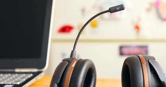 Black and brown headset near laptop computer, illustrating virtual call centers in the cloud