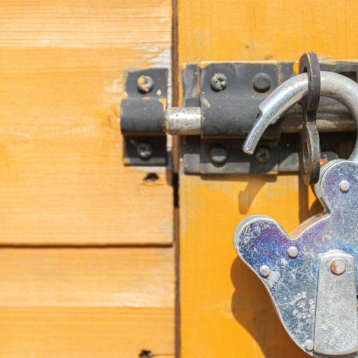 Wooden door secured with a padlock, illustrating securing a virtual environment