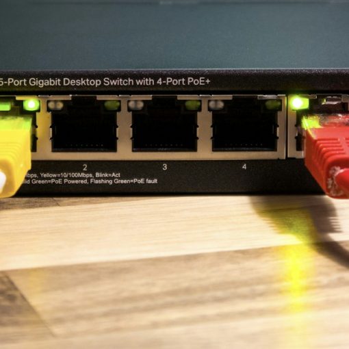 A network switch with ethernet cables connected, illustrating virtual networking's impact on the industry