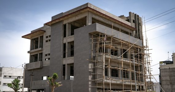 A concrete building under construction with bamboo scaffolding, illustrating virtualization 2.0 for cloud computing