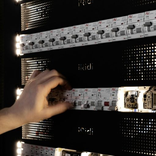 A hand adjusting components in a glowing server rack, illustrating the future of virtualization management