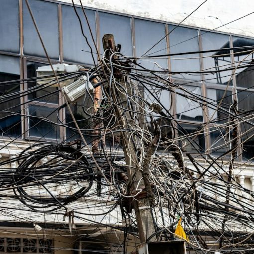 Tangled electrical wires on a utility pole, illustrating security after virtualization