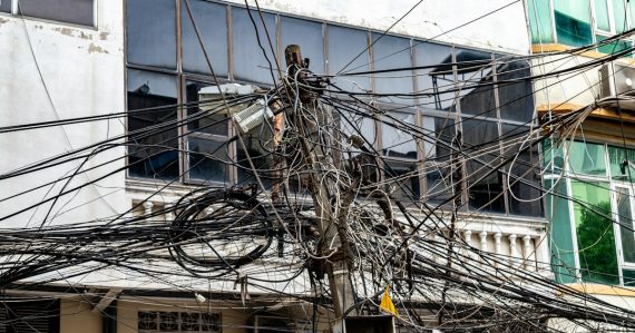 Tangled electrical wires on a utility pole, illustrating security after virtualization