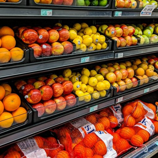 Shelves of fresh oranges, apples, lemons, and limes in a grocery store, illustrating Target's server virtualization