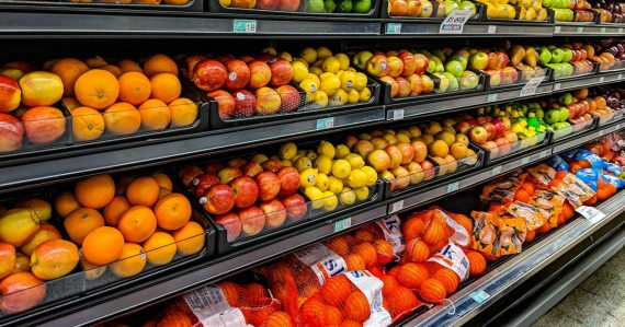 Shelves of fresh oranges, apples, lemons, and limes in a grocery store, illustrating Target's server virtualization