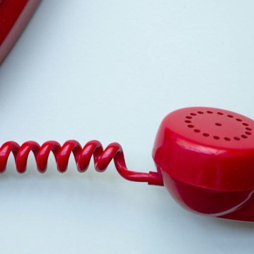 Red corded phone, illustrating VoIP auto attendant for small businesses