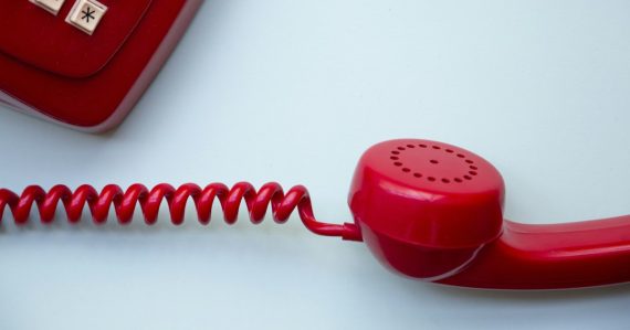 Red corded phone, illustrating VoIP auto attendant for small businesses