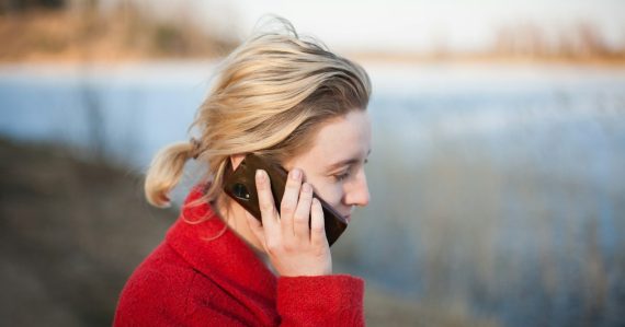 Woman taking a phone call, illustrating VoIP growth