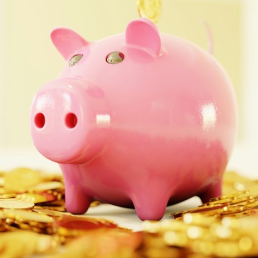 A pink piggy bank surrounded by a pile of gold coins, illustrating VoIP migration savings