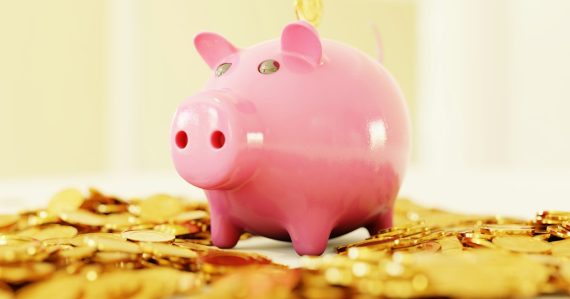 A pink piggy bank surrounded by a pile of gold coins, illustrating VoIP migration savings