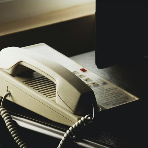 White and black ip desk phone, illustrating security of Cisco VoIP phones