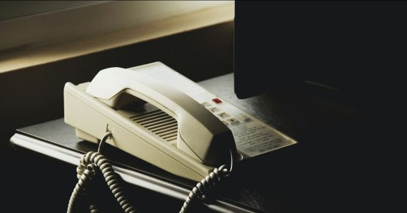 White and black ip desk phone, illustrating security of Cisco VoIP phones