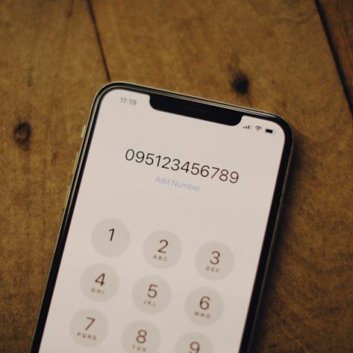 A cell phone sitting on top of a wooden table, illustrating VoIP security for small businesses