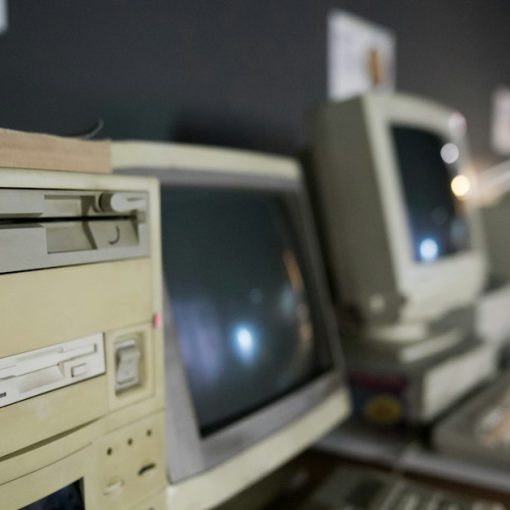 A row of old computers sitting on top of a desk, illustrating Windows ThinPC