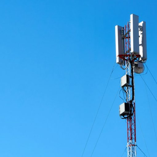 Cell tower with wireless antennas against a blue sky, illustrating network functions virtualization